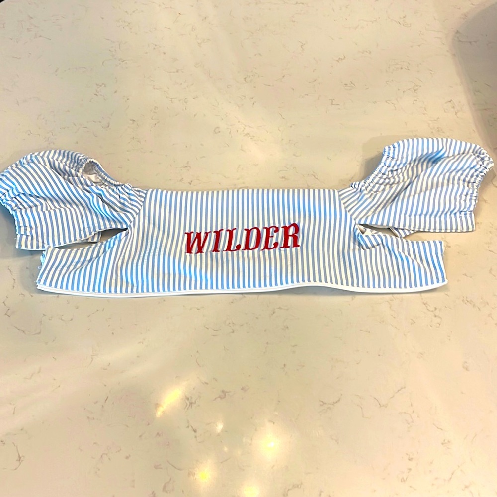 Seersucker puddle jumper cover with the monogram “WILDER” Charming Mary brand.